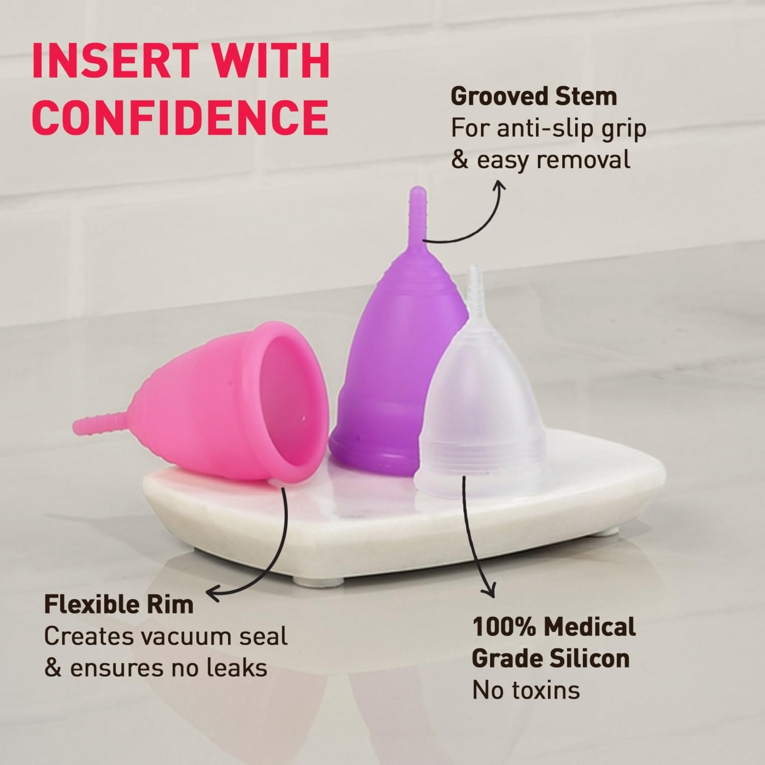 Menstrual cups in pink, purple, and clear